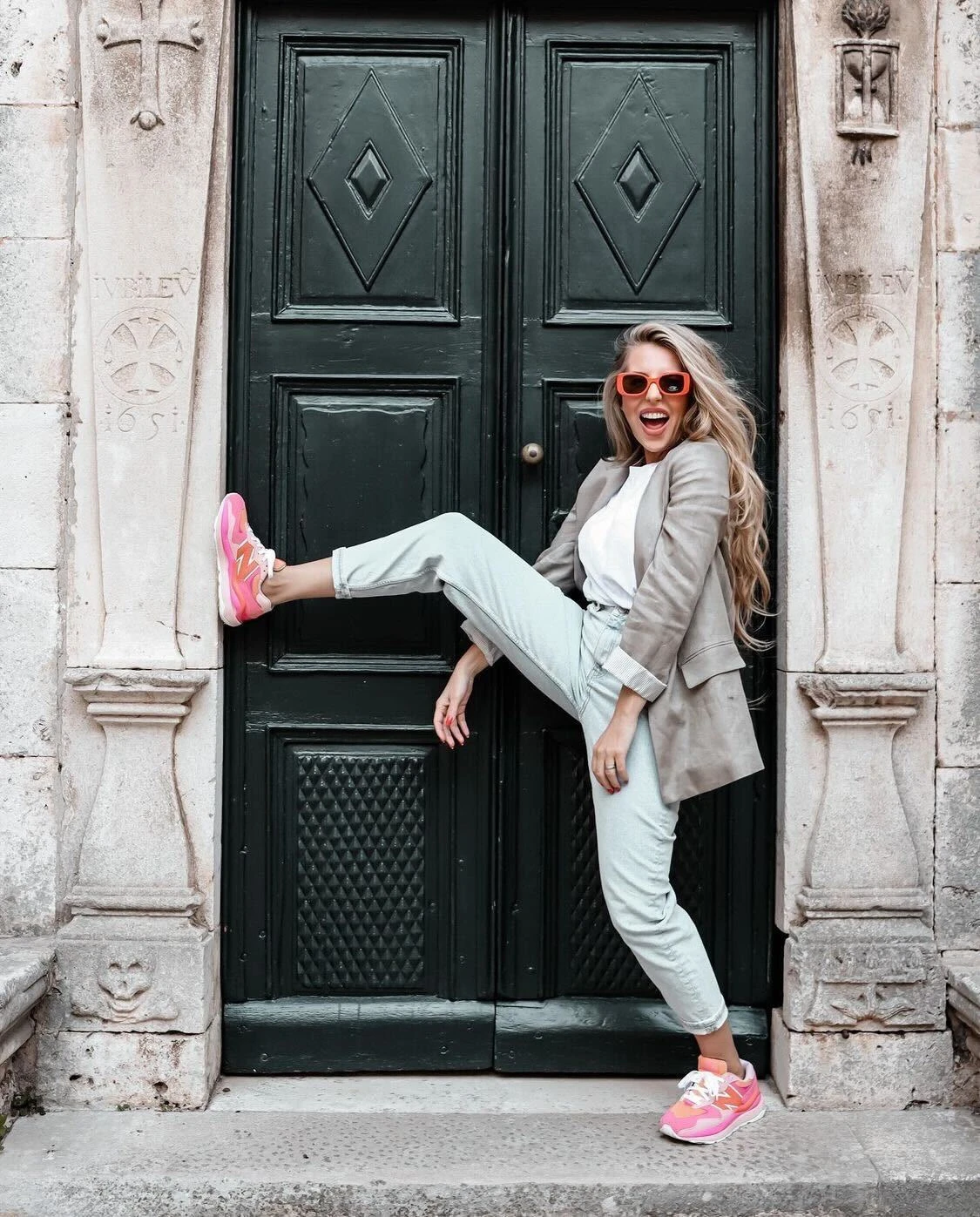 Hajdi Korošec Jazbinšek in front of an ornate doorway