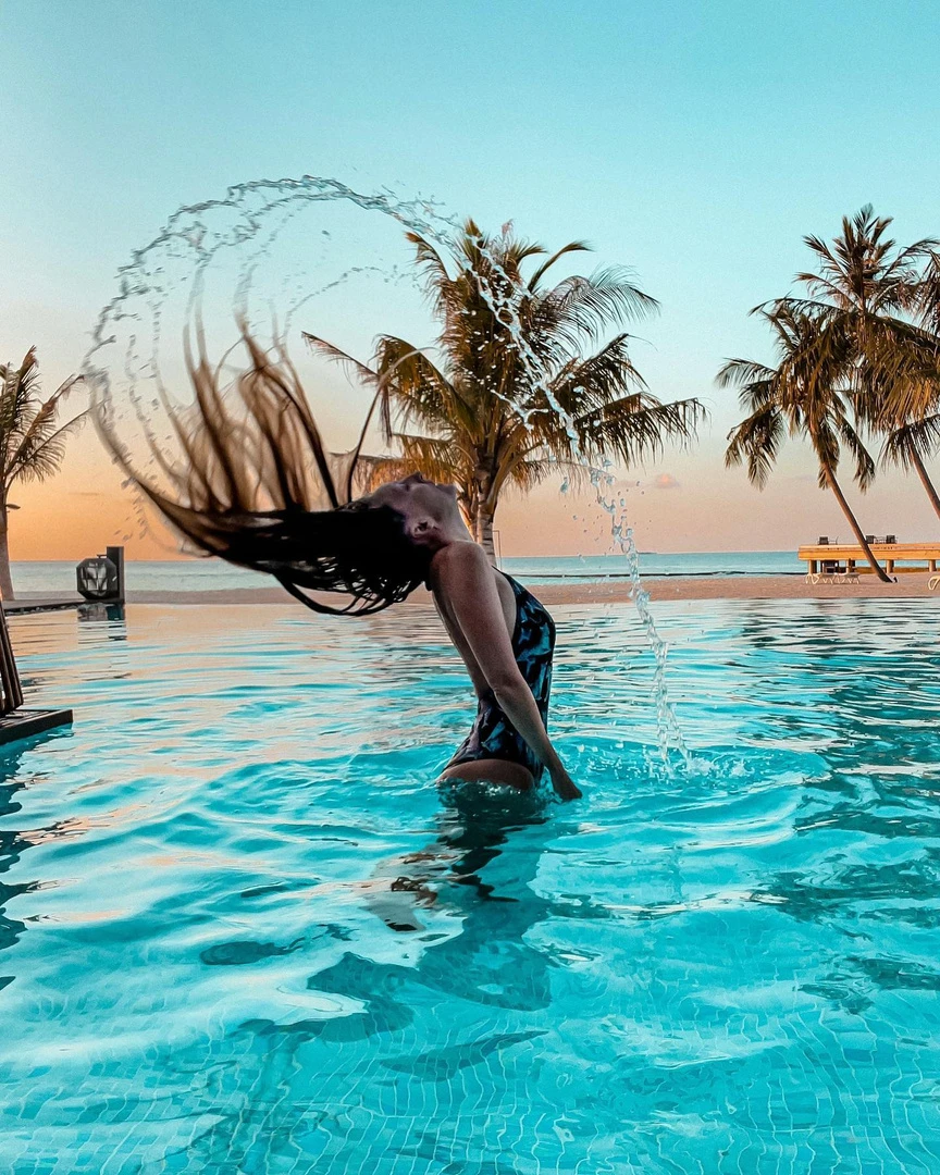 Hajdi in a swimming pool at sunset